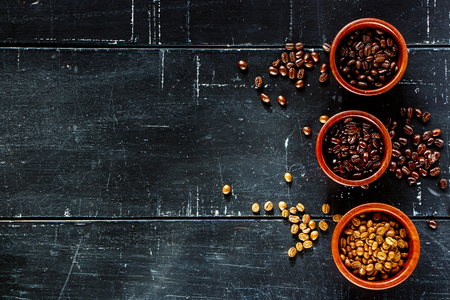 Different various of coffee beans on dark vintage background with space for text. Top view.の写真素材