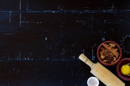 Top view of baking ingredients with rolling pin and brown sugar on dark vintage background with space for text.の写真素材