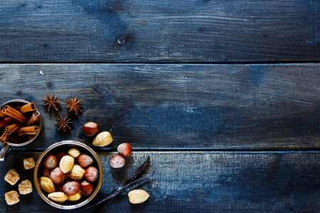 Top view of baking concept background with aromatic spices and nuts over dark wood. Christmas and holidays concept. Copy space.の写真素材
