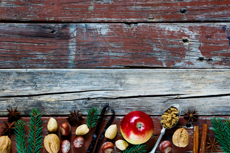 Christmas and holidays concept - baking background with ingredients for apple pie - nuts and spices in rural kitchen. Copyspace. Top view.の写真素材