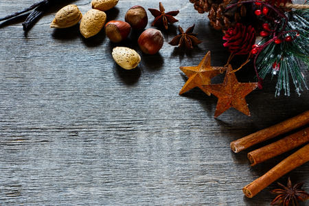 Christmas time with spices and nuts on wooden background with space for text.の写真素材