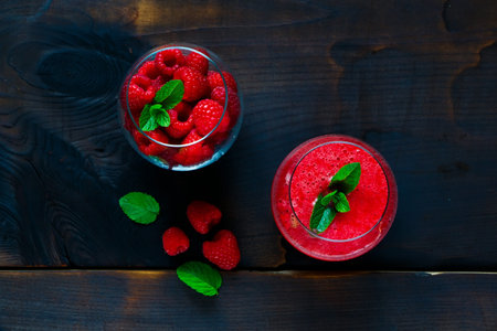 Top view of homemade raspberry smoothie with fresh berries on dark rustic background, copy space. Healthy eating, Detox or Diet conceptの写真素材