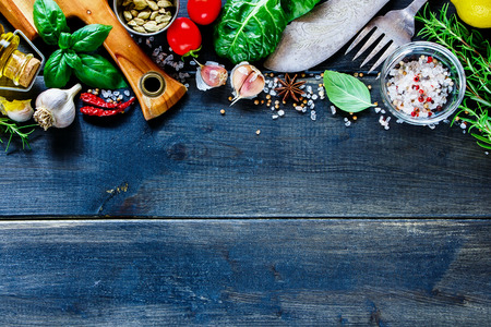 Tasty cooking set with vintage cutlery and organic various ingredients on dark wooden rustic background, border, place for text, top view. Vegan food, vegetarian and healthy eating concept.の写真素材