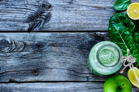Healthy green smoothie and ingredients on rustic wooden background, selective focus - superfoods, detox, diet, health, vegetarian food conceptの写真素材