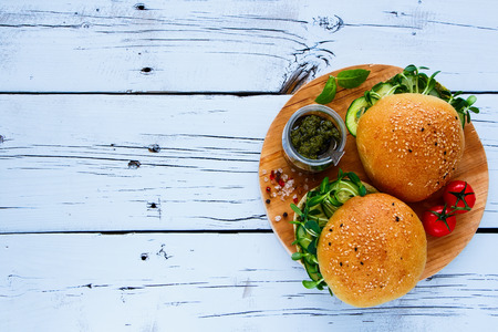 Gluten free vegan sandwiches made with pesto sauce, cucumber, basil and sprouts on white wooden background. Top view. Flat lay style.の写真素材