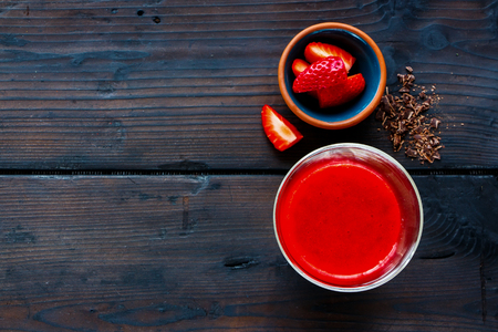 Tasty red smoothie with strawberry and chocolate in mason jar on old wooden background, selective focus. Clean eating, dieting, weight loss, vegetarian, vegan food conceptの写真素材