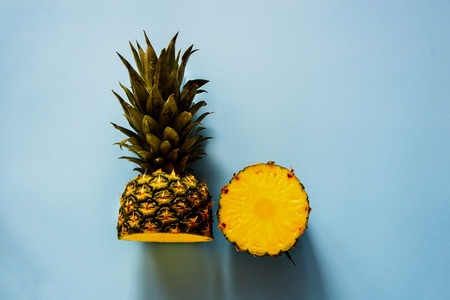 Pineapple on blue background flat lay. Tropical fruit. Useful natural organic food. Summer concept. Style minimalist. Top viewの写真素材