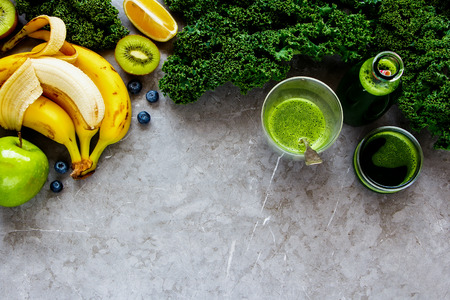Making fresh green smoothie. Flat-lay of ingredients for making detox smoothie drink over grey concrete background - Imageの写真素材