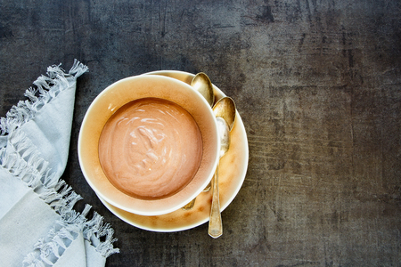 Flat-lay of chocolate yogurt parfait in bowl on concrete background - Imageの写真素材
