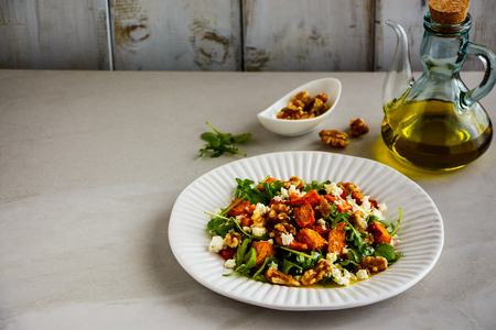Sweet potato salad with arugula, walnut and feta cheeseの写真素材