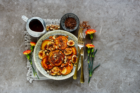 Flat lay of pancakes in plate with banana, chocolate and almonds captured from aboveの写真素材