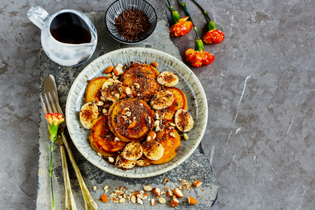 Pancakes with banana, chocolate and almonds close upの写真素材