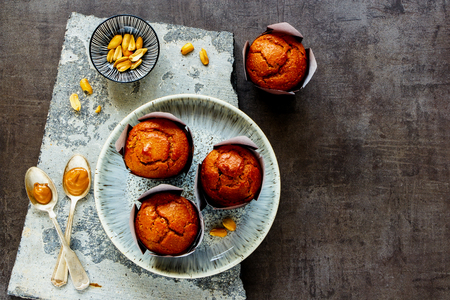 Flat-lay of peanut butter muffins on stone board captured from aboveの写真素材