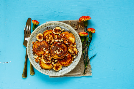 Flat-lay of pancakes on blue background top viewの写真素材