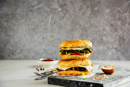 Fried egg sandwich with mushrooms on stone boardの写真素材