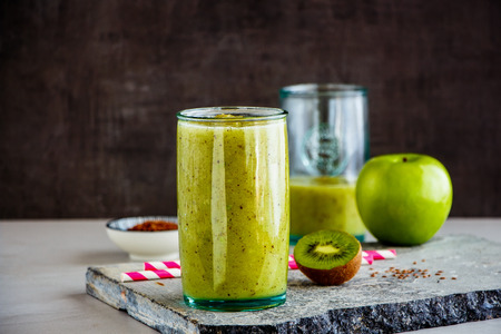 Freshly healthy green smoothie jars on stone boardの写真素材