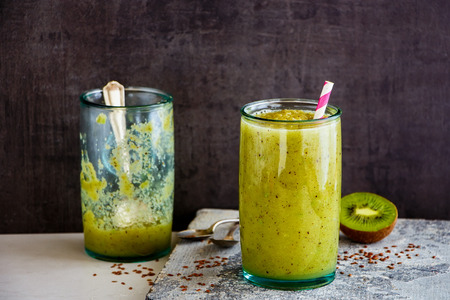Fresh green smoothie in jars on stone board close upの写真素材