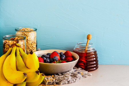 Fruits, nuts, honey and oat flakes on blue background. Zero waste shopping, Recycling, Sustainable eco-friendly lifestyle conceptの写真素材