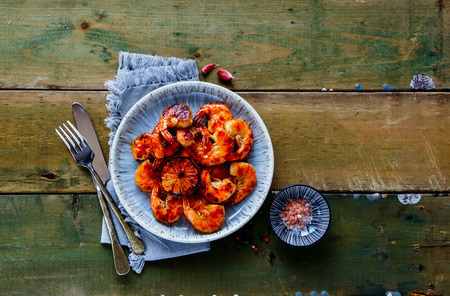 Flat lay of Grilled pink Prawn Shrimp in plate over wood captured from aboveの写真素材