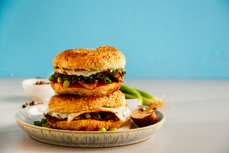 Freshly made mushrooms and fried egg sandwich on blue backgroundの写真素材