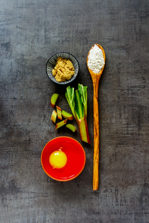 Making cake with rhubarb on vintage background flat lay top viewの写真素材
