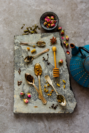 Flat lay of dry tea composition on stone board.の写真素材