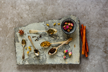 Tea types backgound from above. Assortment of dry tea on stone board flat lay.の写真素材