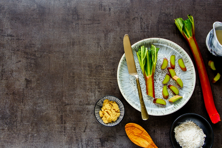 Cooking rhubarb cake on vintage background flat lay top viewの写真素材