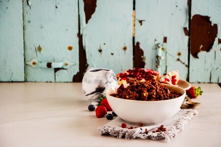 Breakfast set with fruit, berry and chocolate granola on turquoise background close upの写真素材