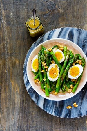 Homemade aspargus and eggs salad with mustard sauce flat layの写真素材