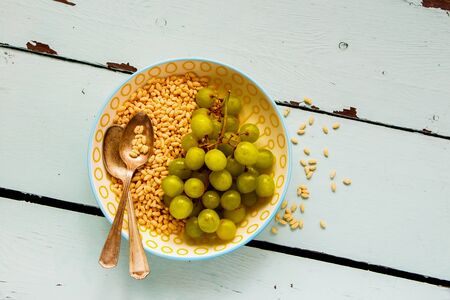 Breakfast Crispy Rice with green grape on turquoise background flat layの写真素材