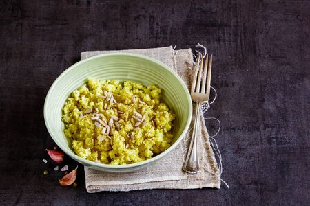 Cauliflower Rice with spices and sunflower seeds in bowlの写真素材