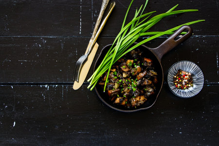 Roasted mushrooms in frying pan on vintage background, flat layの写真素材