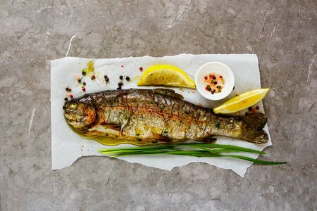 Healthy Baked Trout Fish with Herbs and Lemon flat layの写真素材
