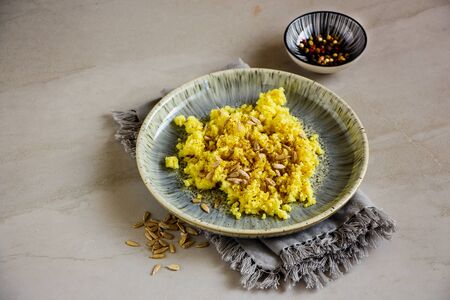 Cauliflower Rice with spices and sunflower seeds in plateの写真素材