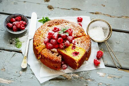 Tasty raspberry yoghurt cake on wooden board, slicedの写真素材