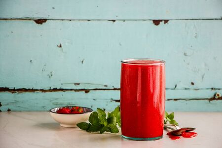 Fresh strawberry smoothie jar on turquoise backgroundの写真素材