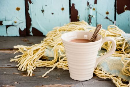Autumn backdrop with cup of hot chocolate on wooden tableの写真素材