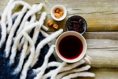 Hibiscus tea cup on autumn wooden background flat-layの写真素材
