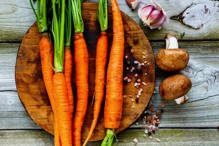 Flat-lay of fresh organic Carrots bunch and vegetable ingredients top viewの写真素材