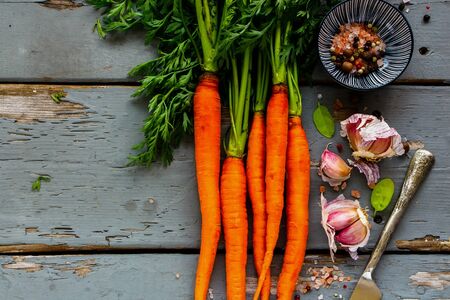 Fresh organic Carrots bunch and vegetable ingredients flat-lay. Healthy food cooking background.の写真素材