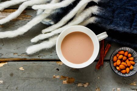 Autumn background and hot chocolate cup on wooden table flat layの写真素材