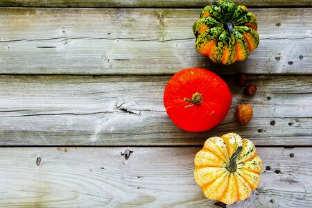Autumn pumpkins on wooden table flat layの写真素材