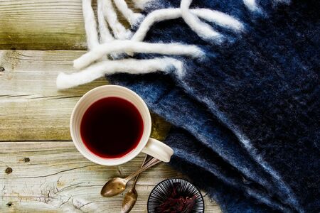 Flat-lay of hibiscus tea in cup on autumn wooden backgroundの写真素材