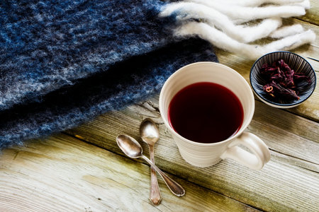 Autumn wooden background and hibiscus tea in cupの写真素材