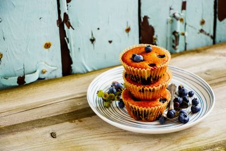 Homemade blueberry muffins on plate close upの写真素材