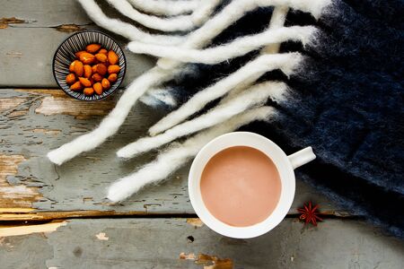 Flat-lay of autumn background with hot chocolate cup on wooden tableの写真素材
