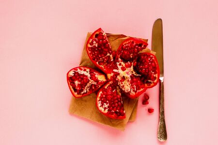 Flat-lay of ripe pomegranate on pink backgroundの写真素材