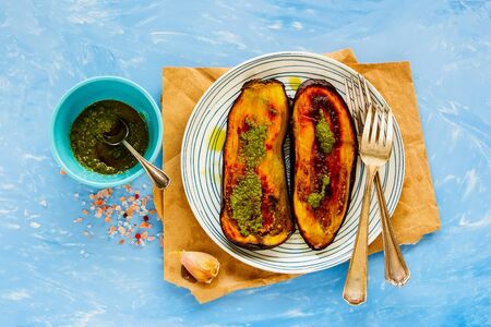 Baked eggplant with pesto sauce on plate flat lay top viewの写真素材