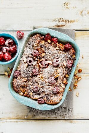 Flat-lay of croissant casserole with almonds, chocolate and raspberriesの写真素材